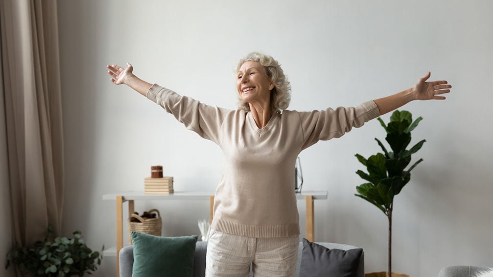 senior woman dancing with arms out