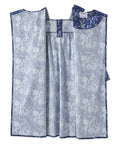A blue and white patterned garment laid flat against a white background, featuring a floral jacquard design with a solid blue collar and matching blue trim.