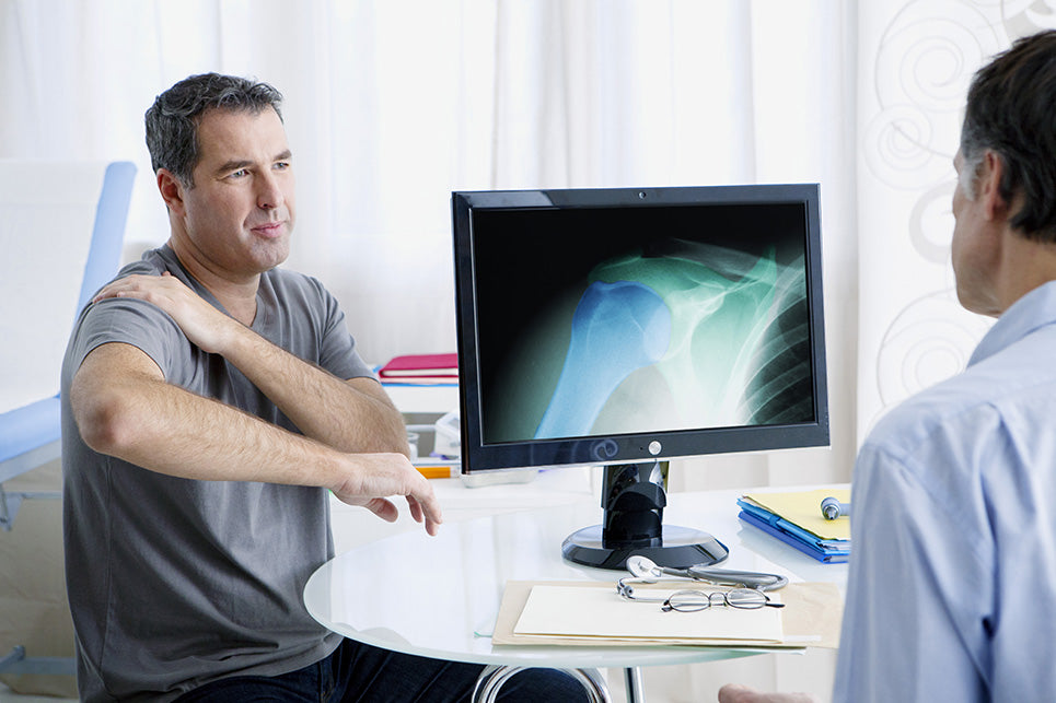 a man at a Rheumatology consultation with a doctor