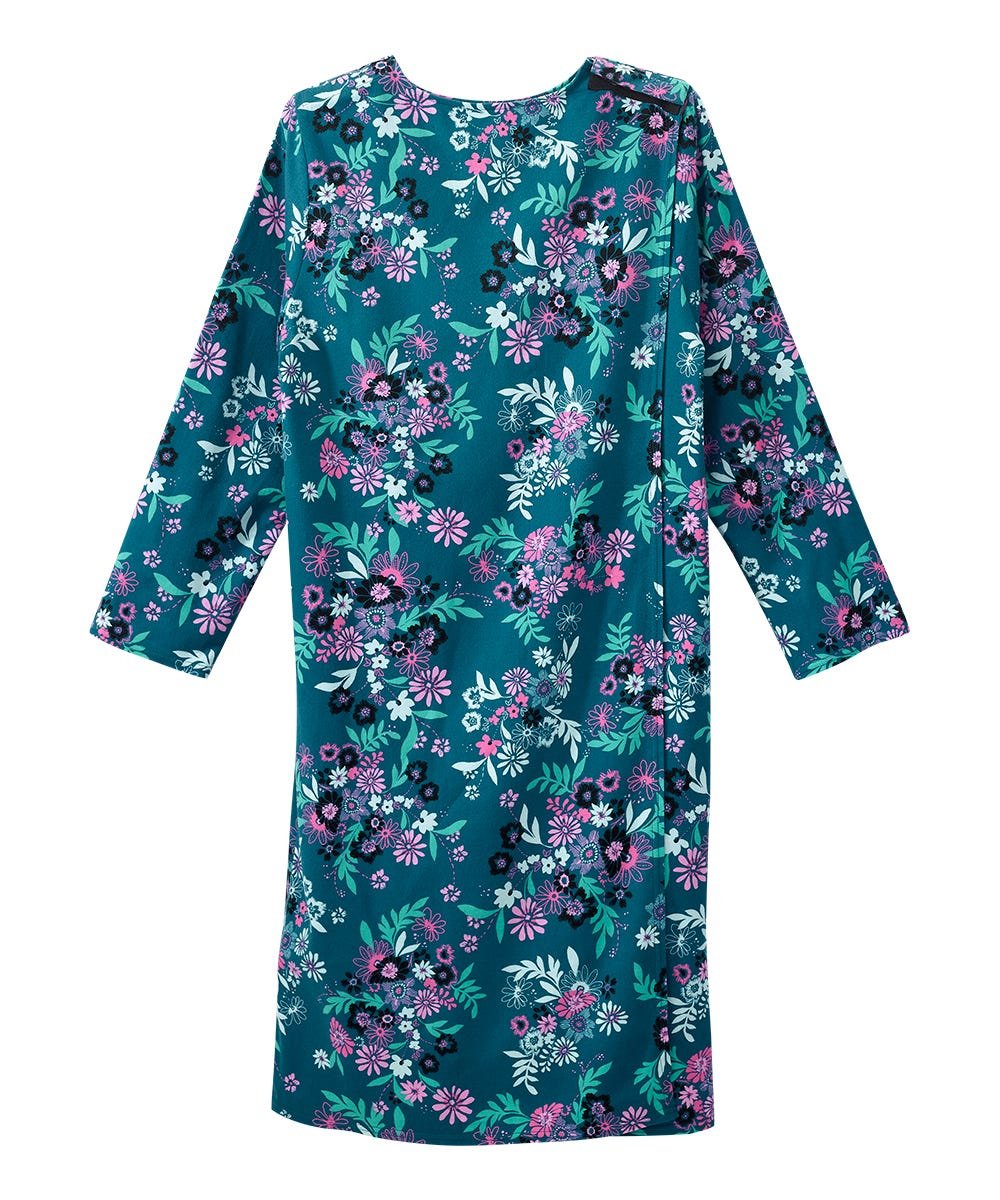 A long-sleeve shift dress with a vibrant teal green base, decorated with an all-over floral pattern in pink, purple, white, and light green, shown against a plain white background.