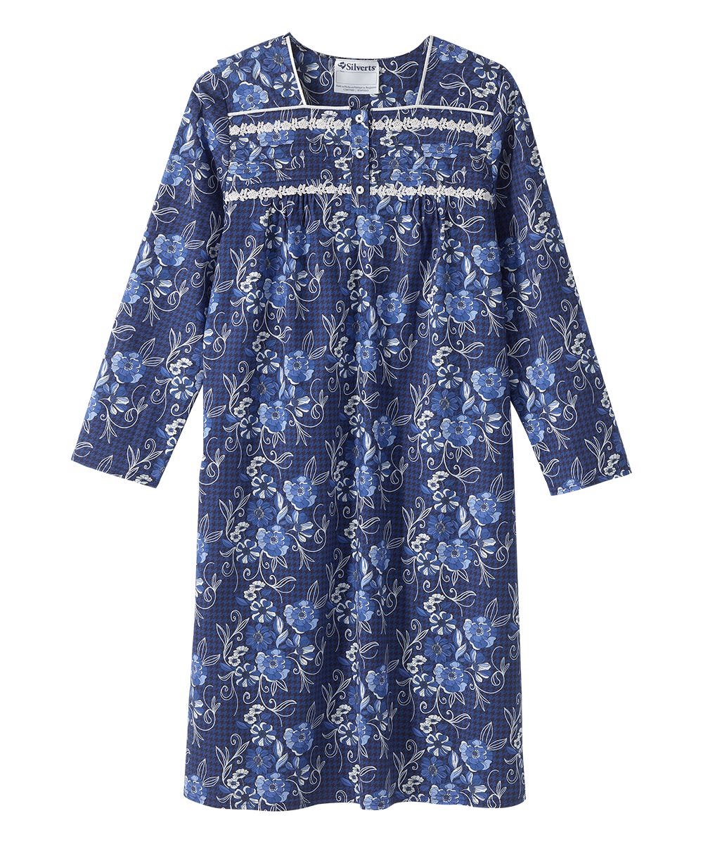 A long-sleeve blue floral nightgown with white embroidered trim across the chest, shown flat against a white background.