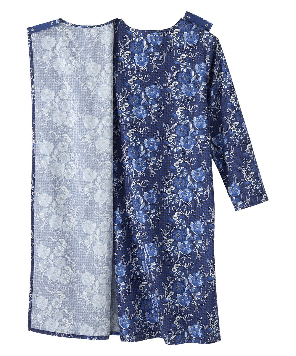 A long-sleeve tunic dress in navy blue with a light blue and white floral print, shown alongside a matching sheer inner lining panel on a plain white background.