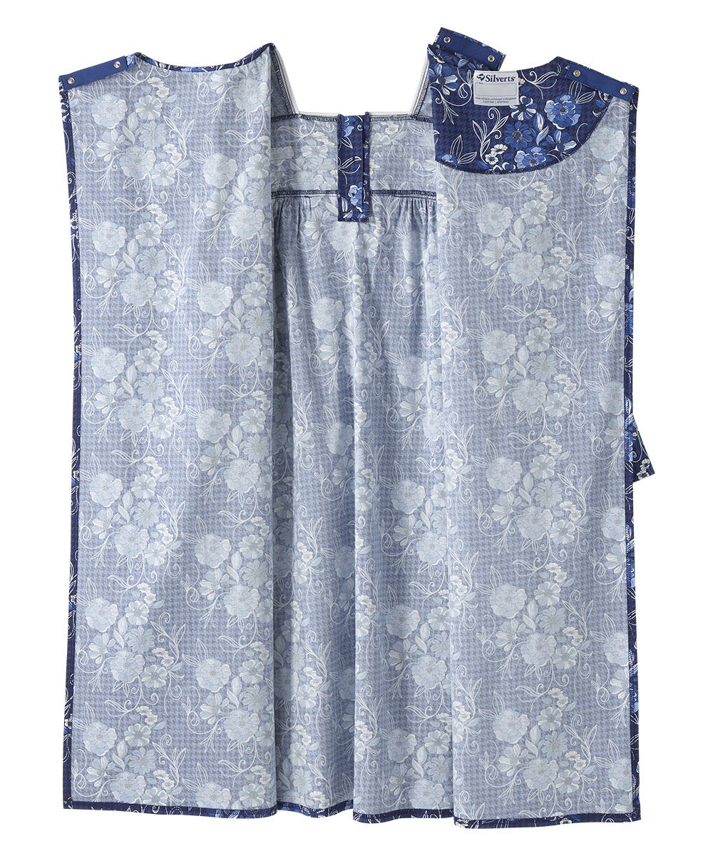 A blue and white patterned garment laid flat against a white background, featuring a floral jacquard design with a solid blue collar and matching blue trim.