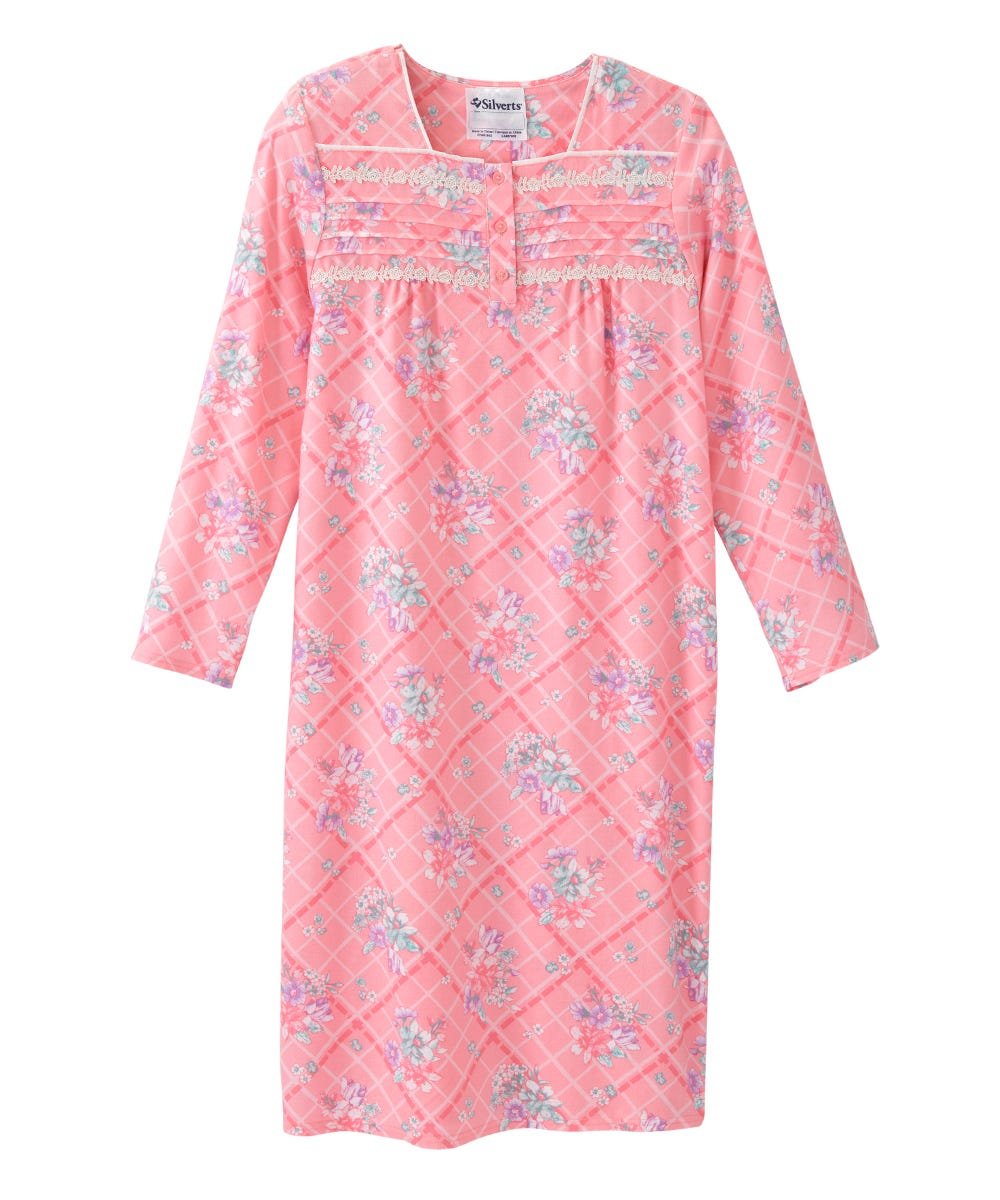 A pink long-sleeve nightgown with a diamond quilted pattern, floral print, and decorative lace trim at the chest, shown against a plain white background.