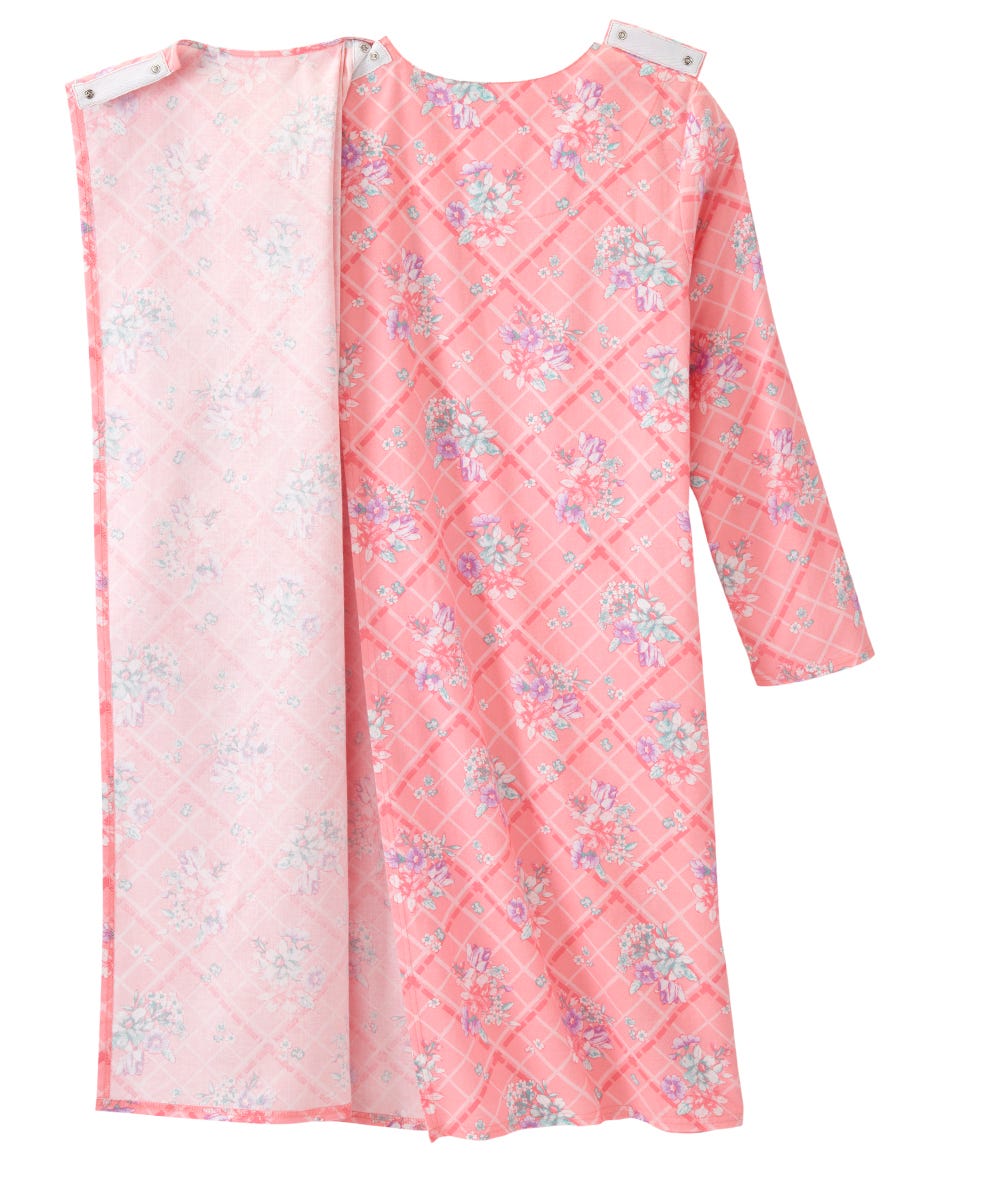 A pink long-sleeve tunic dress with a diamond-quilted pattern and floral print, shown with its matching inner lining or second side panel on a white background.